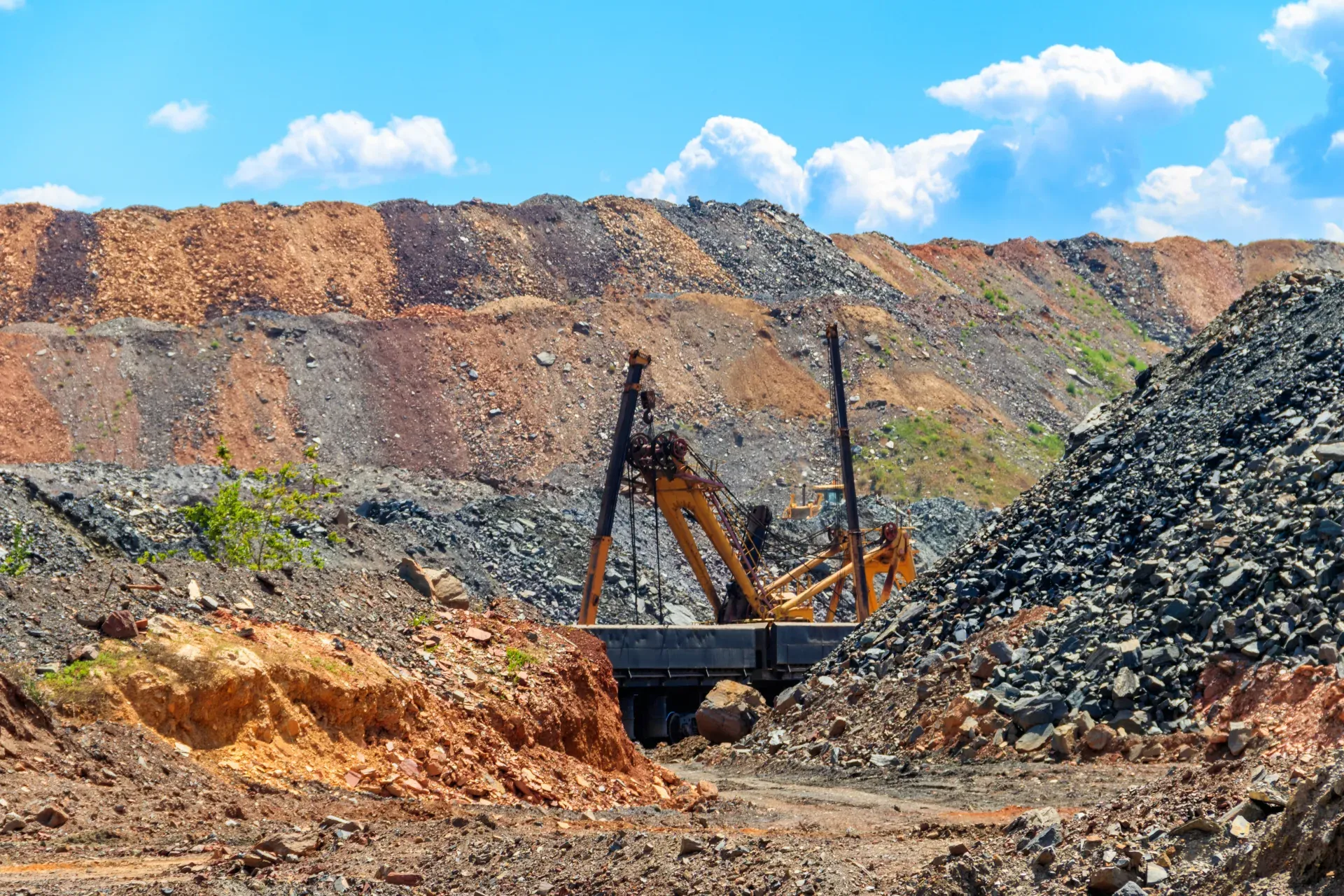 Excavator working an open-pit iron ore quarry